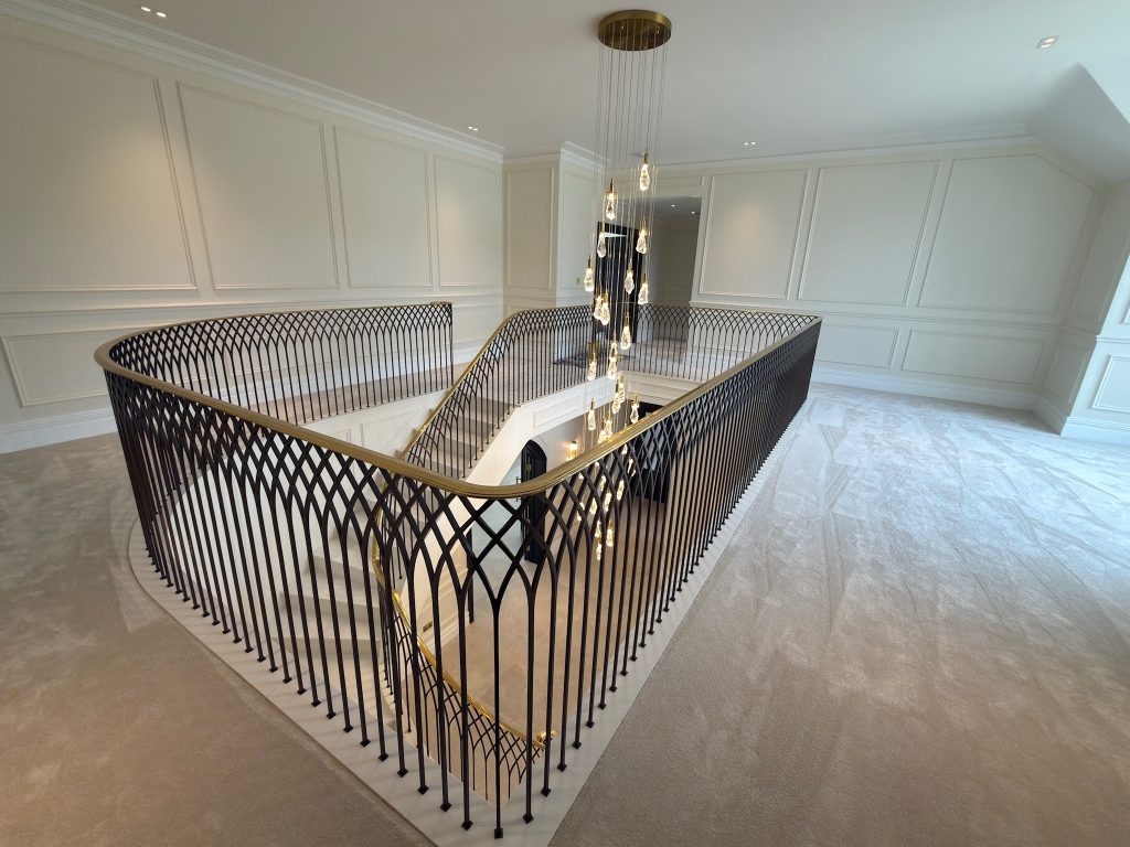 an elegant balustrade featuring gilding and wrought iron